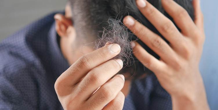 A person holding hair in their head

AI-generated content may be incorrect.